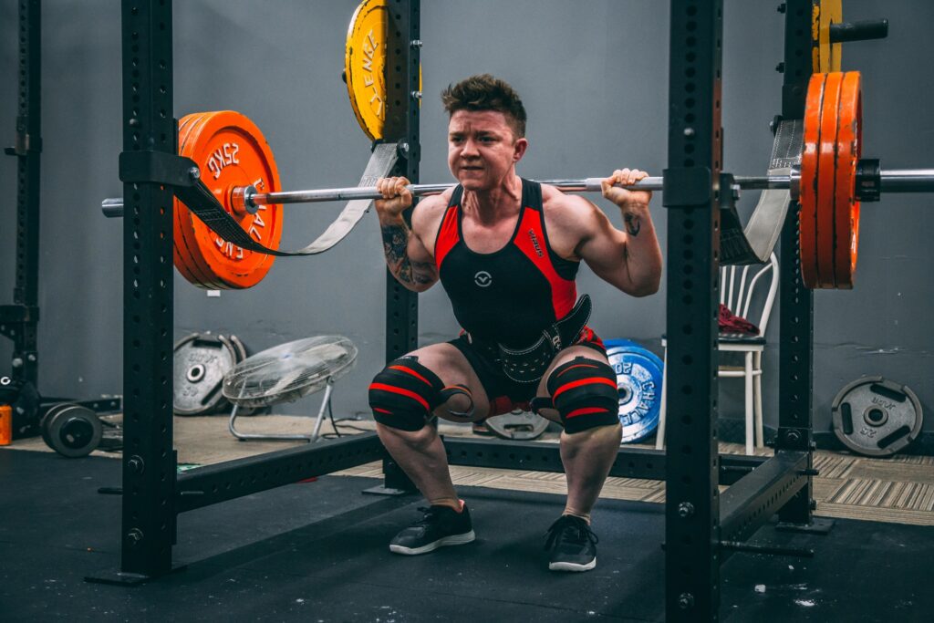 Man squatting inside a rack