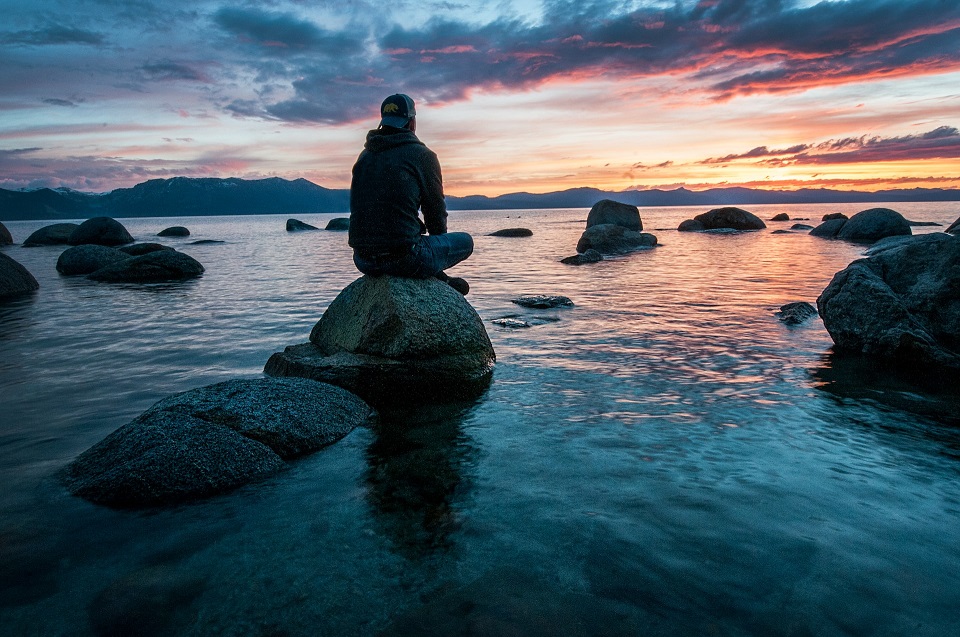 Man meditating on a rock