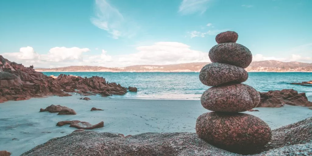 Balanced stones on top off each other on a beach