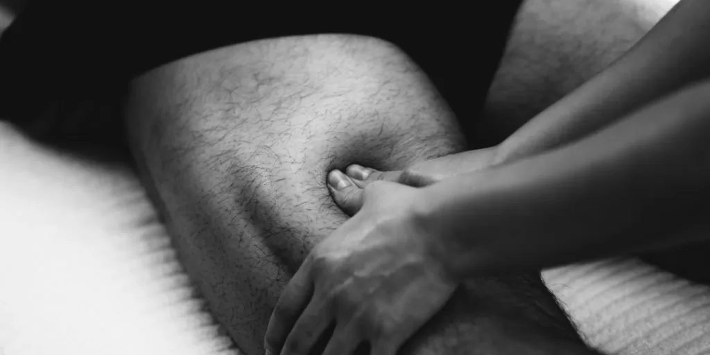 Sports massage therapist performing deep tissue massage