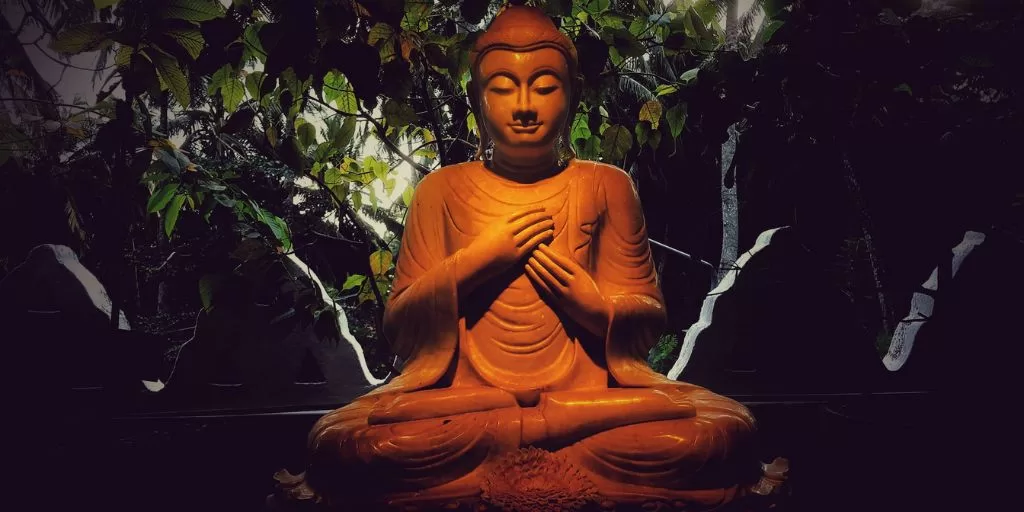 A buddha statue among leaves