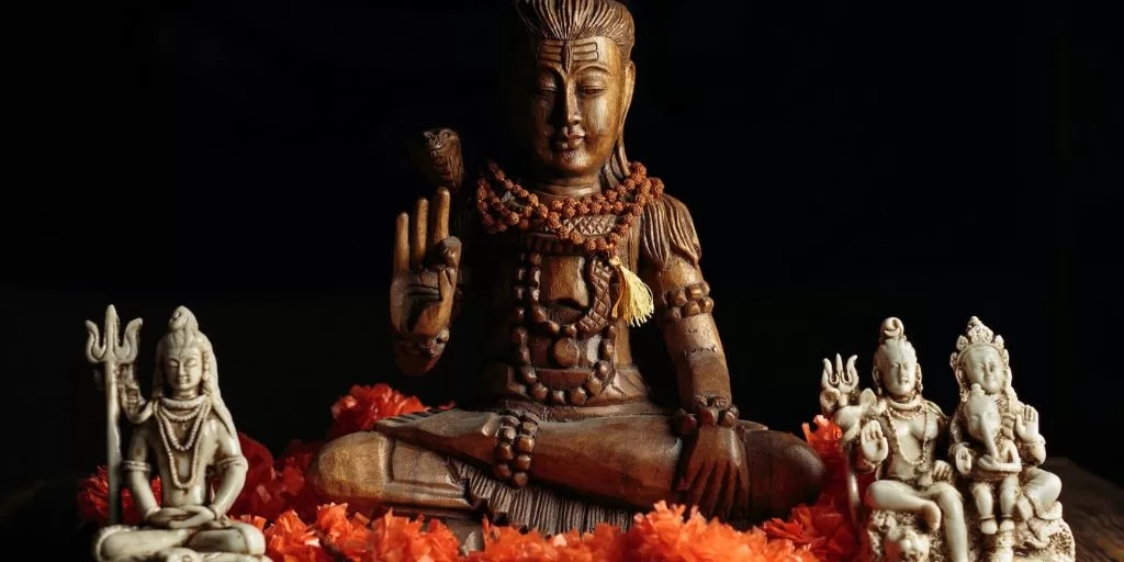 A small statue of Buddha performing a mudra