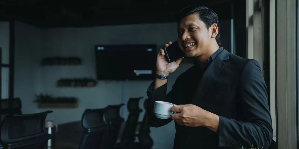 An entrepreneur with a positive mindset talking on the phone