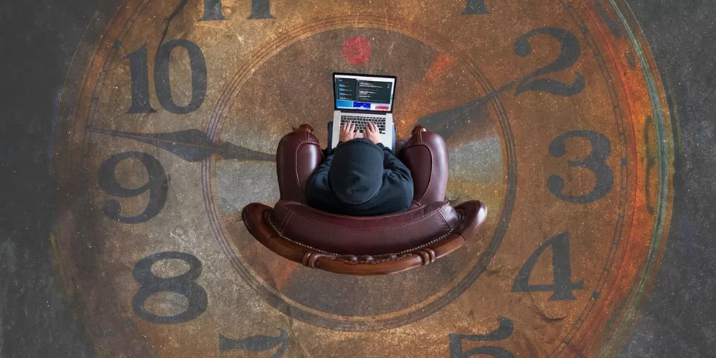 Calm Mind Under Pressure: A man working on a laptop and sitting on large clock paining