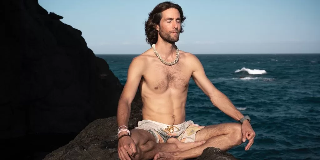 Wellness: Man meditating on a rock