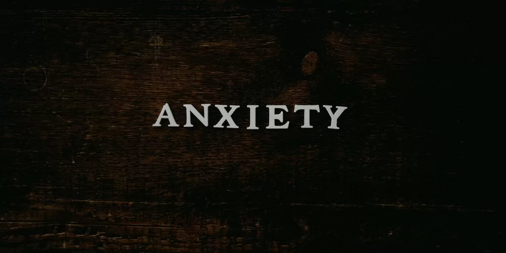 White letters on a table forming the word "anxiety"