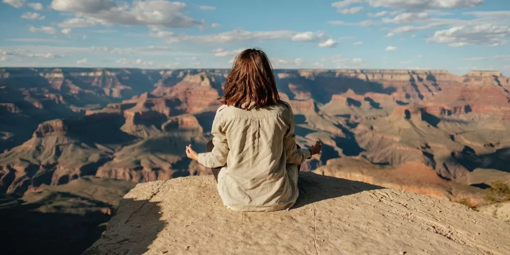 A woman meditating at the desert