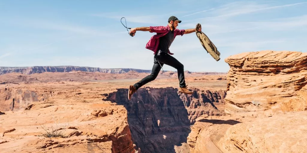 A man jumping over a cliff