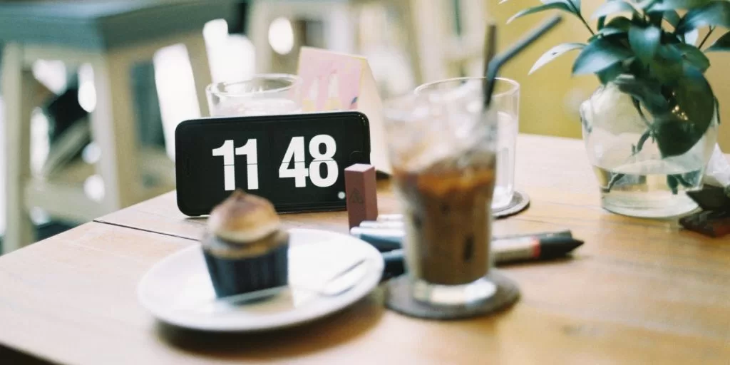 A clock on the table during a business meeting