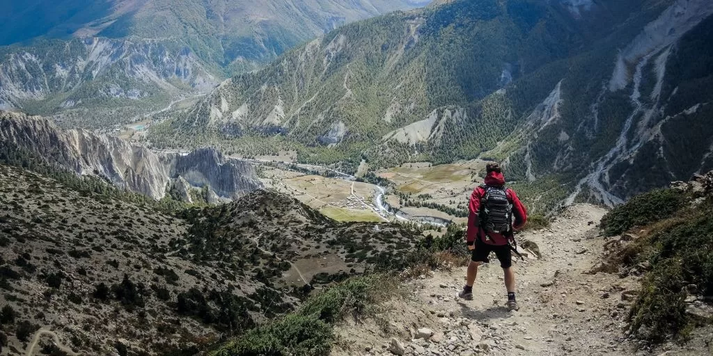 Success mindset: A mountain hiker taking a challenge as an opportunity