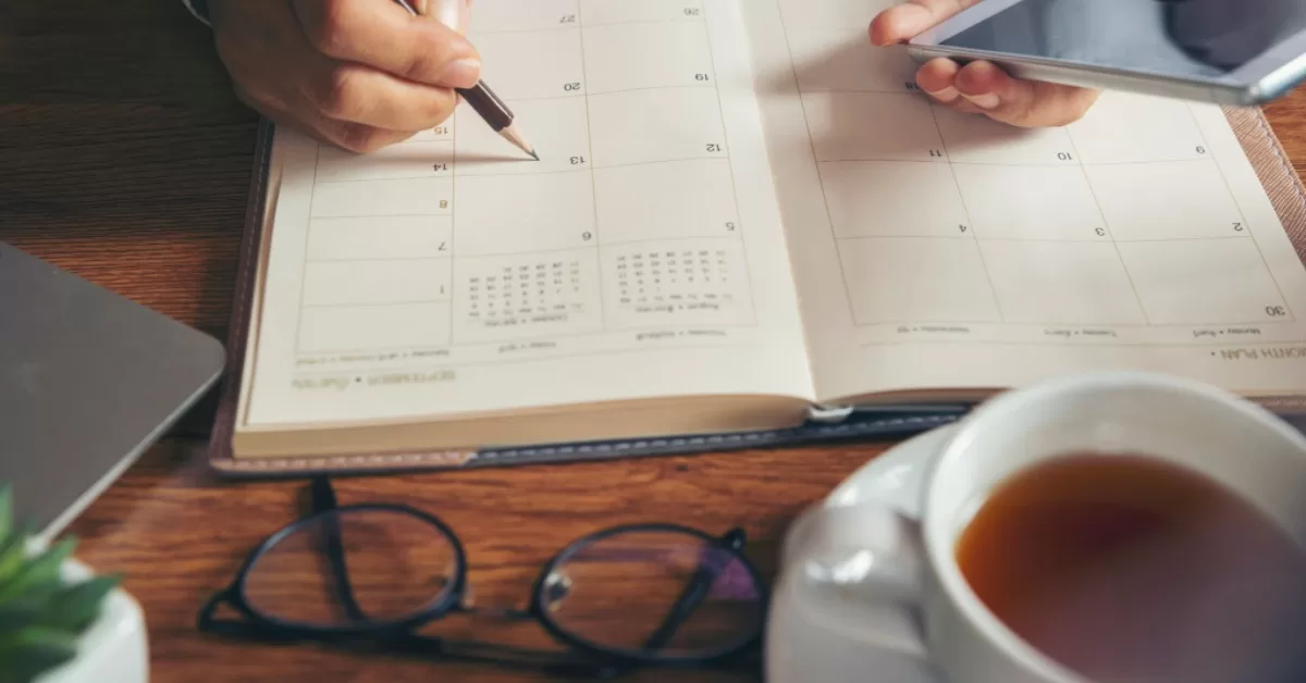 A person noting down their goals in a journal