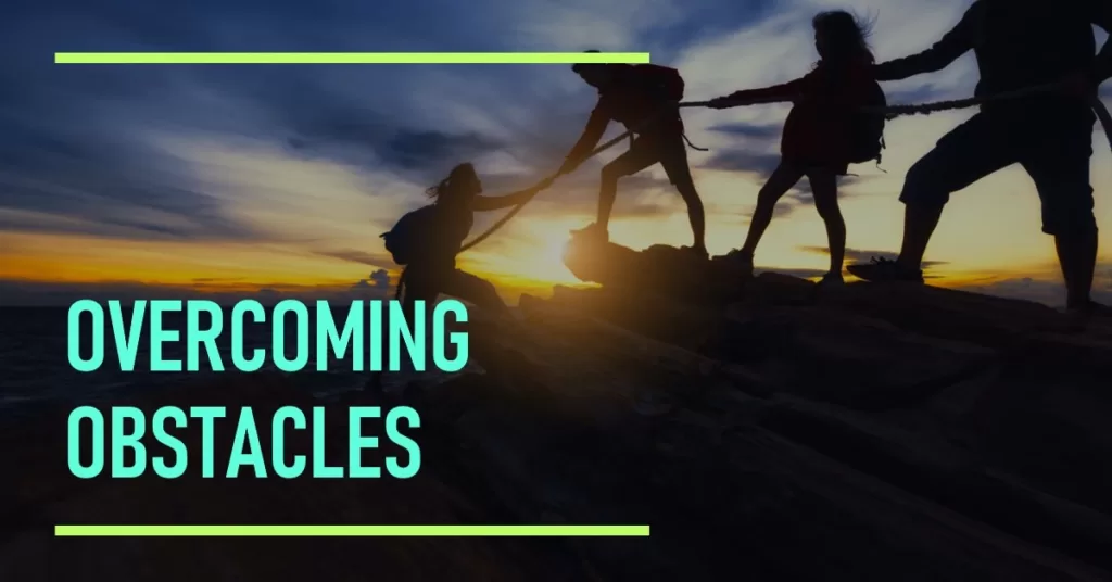 Overcoming obstacles: A group of friends helping each other climb a mountain