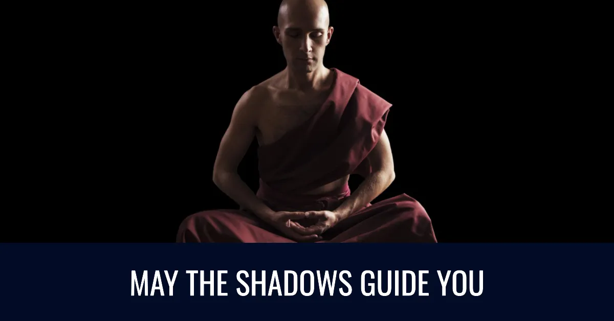 Focused monk meditating in darkness