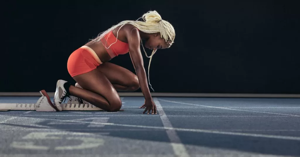 Mental Training In Sports - A sprinter gathering mental strength before the race