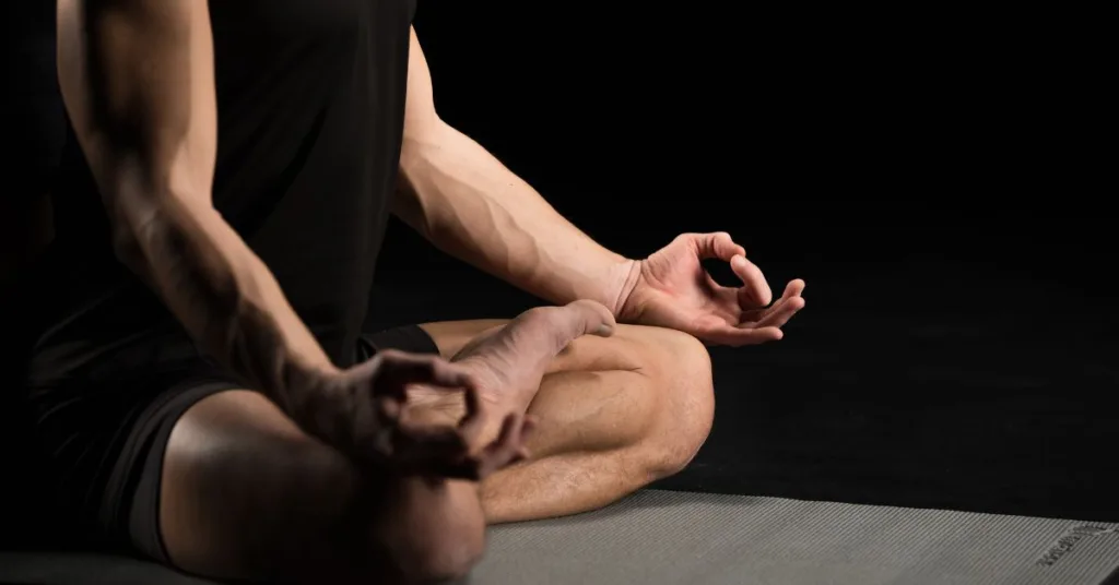 A Man Practicing Heartbeat Meditation On A Yoga Mat