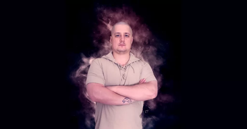 Daniel Domaradzki - Chaos magick coach standing with his arms crossed