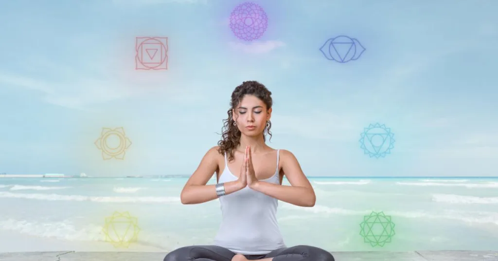 A woman peacefully meditating with chakras