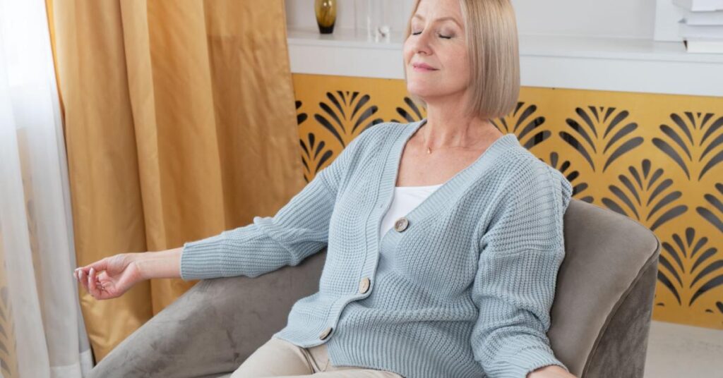 Elderly Woman Practicing Breathing Meditation At Home for Relaxation Purposes