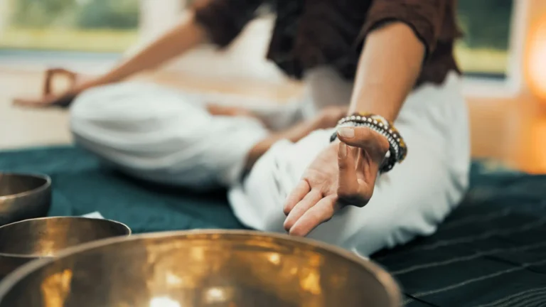 Meditation adept meditating with the singing bowls