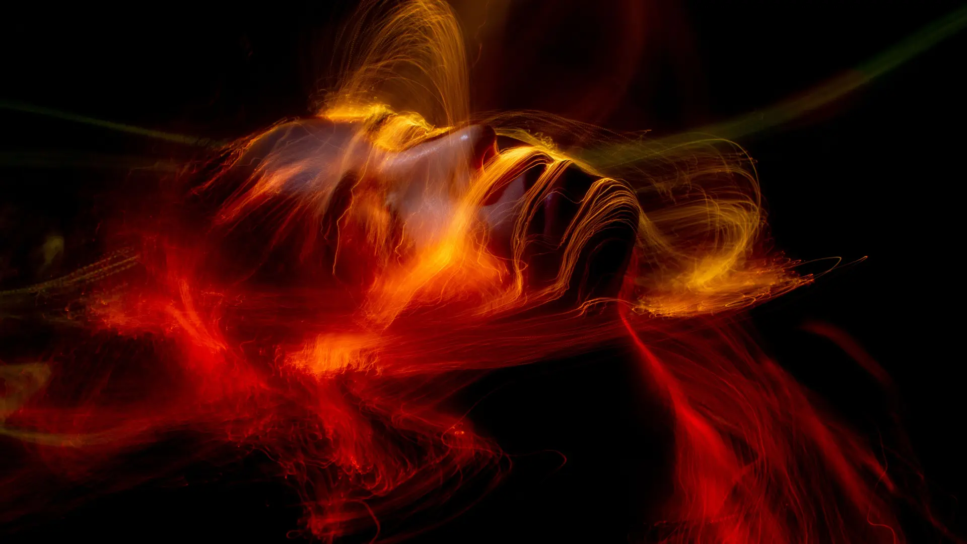 Etheric aura (biofield) covering an emerging human face