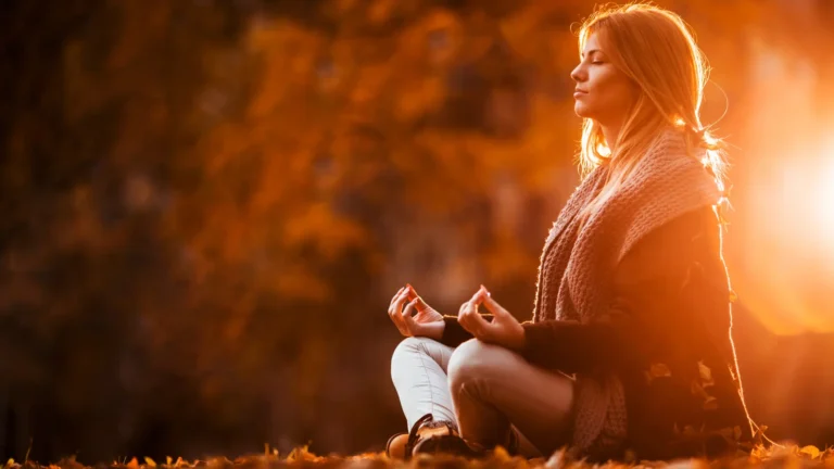 A woman meditating in a park to regulate her emotions