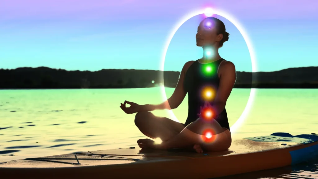 A woman meditating with Kundalini on a kayak