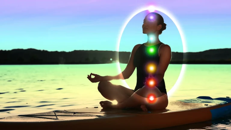 A woman meditating with Kundalini on a kayak