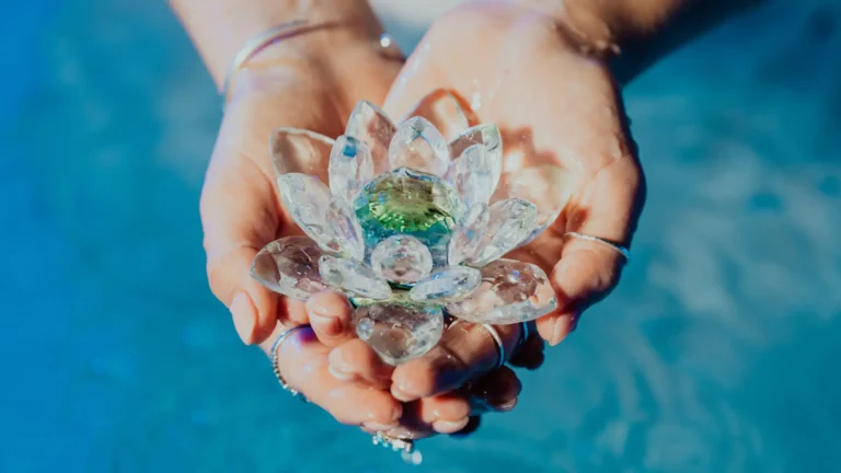 Lotus flower made of crystals held in female hands