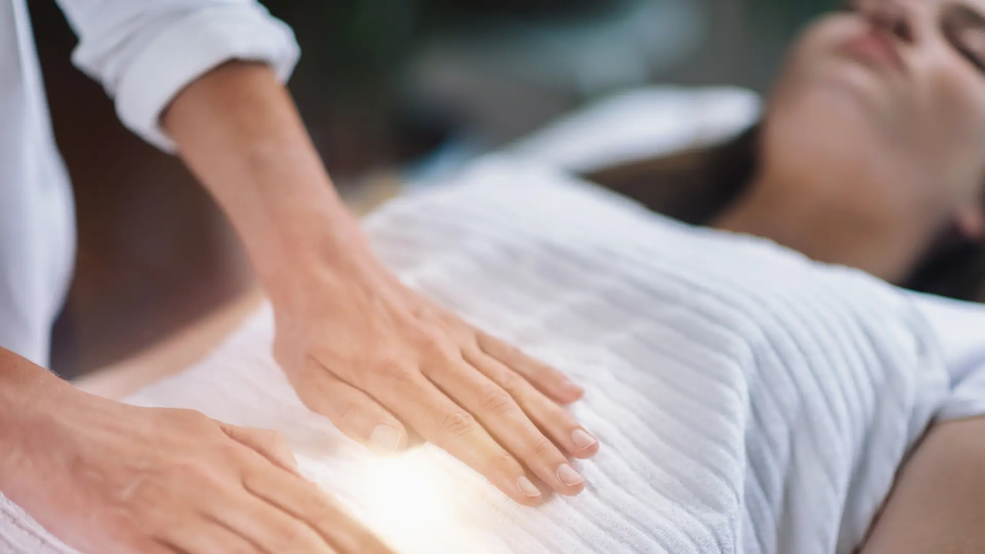 Pregnant woman receiving a Reiki healing treatment