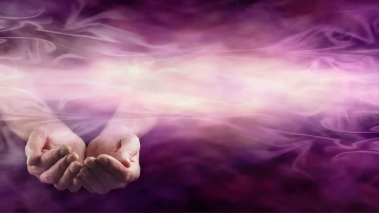 Hands of an energy healer summoning pranic waves of healing energy