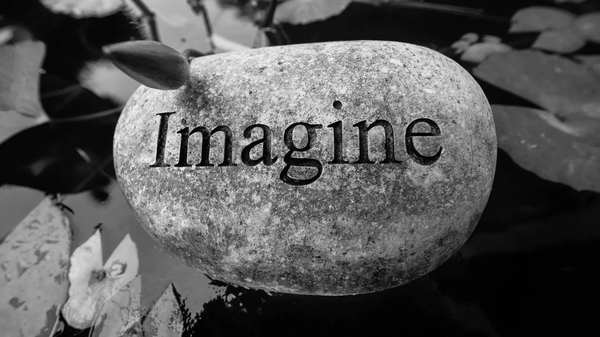 A stone with the word 'imagine' carved on it