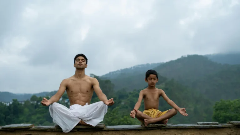 2 Indian people practicing yogic meditation (Dhyana) in the mountains