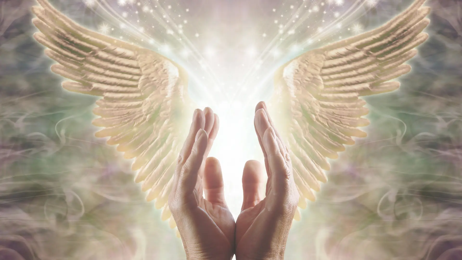 Hands of a healer emitting healing Reiki energy and an etheric hologram of angel wings