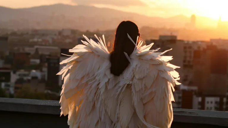 A winged angel standing at the rooftop, looking at the city from above